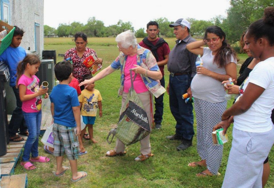 Sr. Thérèse Cunningham, center, spends pre-pandemic time with guests at La Posada Providencia, an emergency shelter in San Benito, Texas.