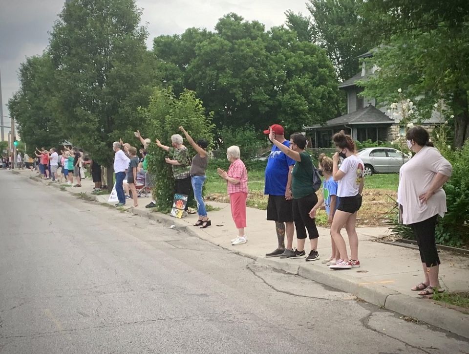 People line up along Troost Avenue in Kansas City, Missouri, for the Pray on Troost event on Juneteenth.