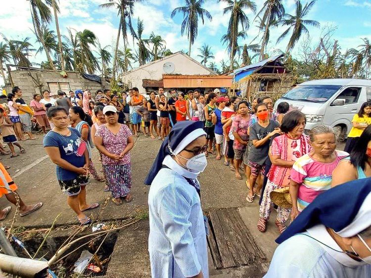 A Mercy sister oversees the distribution of relief goods in San Francisco, Southern Leyte. (Courtesy of the Religious Sisters of Mercy)
