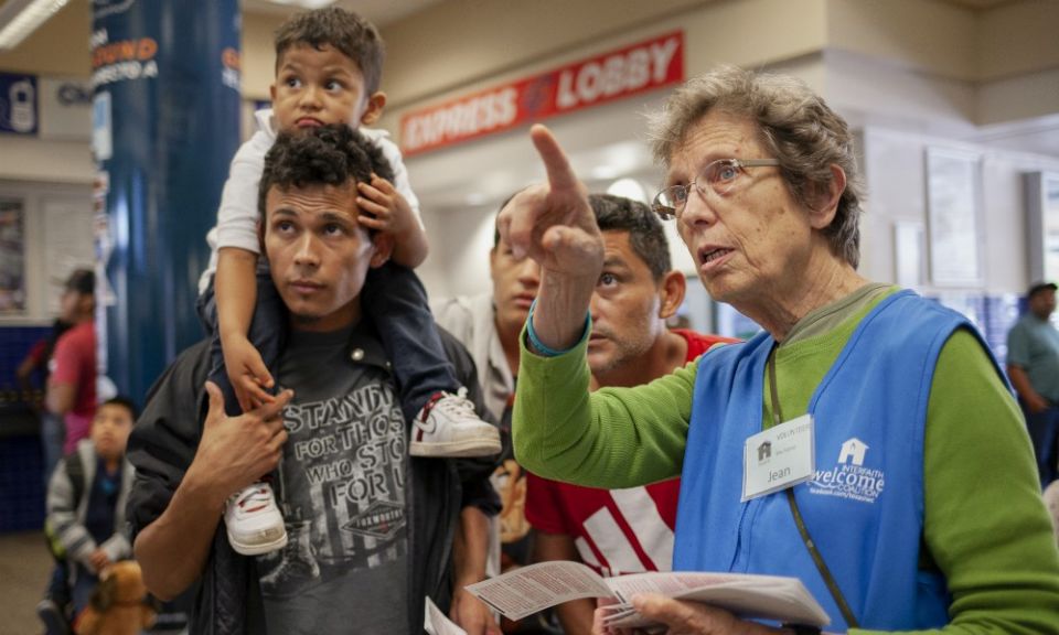 Sr. Jean Durel helps Cyrilo Garcia, left, his son, Kelvin Naum, 3, and Juan Jose Nuñez pinpoint their departure time June 18 at the San Antonio Greyhound station. (Nuri Vallbona) Sr. Jean Durel helps Cyrilo Garcia, left, his son, Kelvin Naum, 3, and Juan Jose Nuñez pinpoint their departure time June 18 at the San Antonio Greyhound station. (Nuri Vallbona)