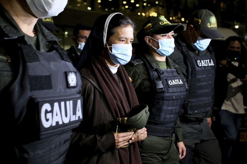 Colombian Sr. Gloria Cecilia Narvaez, second from left, is escorted by police after her arrival at El Dorado airport in Bogota, Colombia, on Nov. 16, 2021, after she was released on Oct. 10 by her kidnappers. (AP Photo/Leonardo Muñoz)