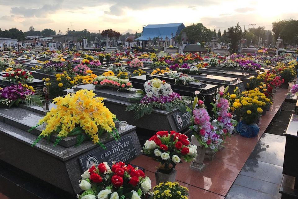 The graves of a parish cemetery in Ho Chi Minh are decorated with flowers in November. (Nguyen)