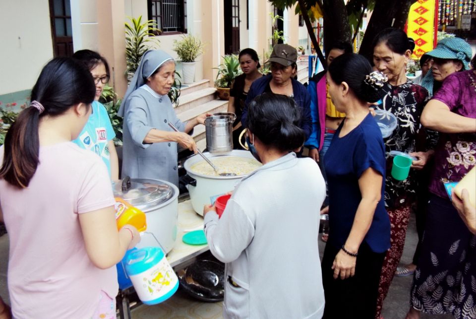 St. Paul de Chartres Sr. Josephine Huynh Thi Ly offers food to hospital patients at her convent in Hue City. (Joachim Pham)