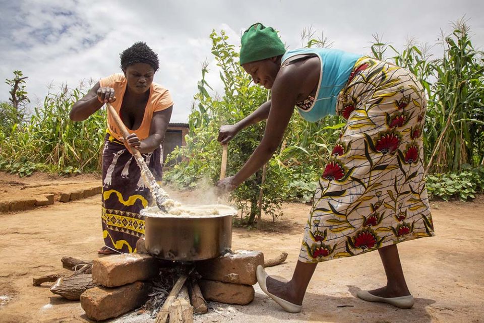 Volunteers for Catholic Relief Services in Zambia preparing a demonstration meal, stressing the need to use local crops and ingredients in meals. (Catholic Relief Services/Dooshima Tsee)