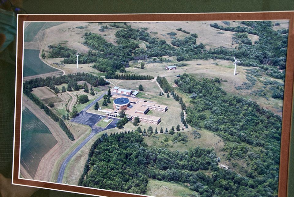 The Sacred Heart Benedictine Monastery in Dickinson, North Dakota, has a framed photo of the community's former convent, which had the first commercial wind turbines in the state. (GSR photo/Dan Stockman)