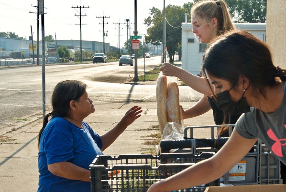 Volunteers hand out food during the twice-weekly food pantry at Ministry on the Margins in Bismarck, North Dakota. (GSR photo/Dan Stockman) 