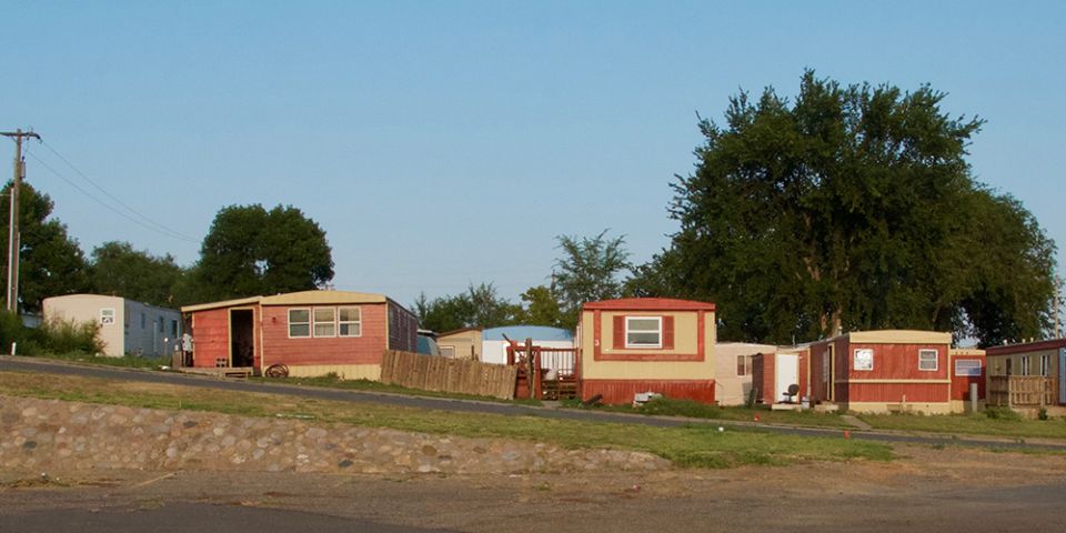 Mobile homes bake in the summer sun across the street from the food pantry at Ministry on the Margins in Bismarck, North Dakota. (GSR photo/Dan Stockman) 