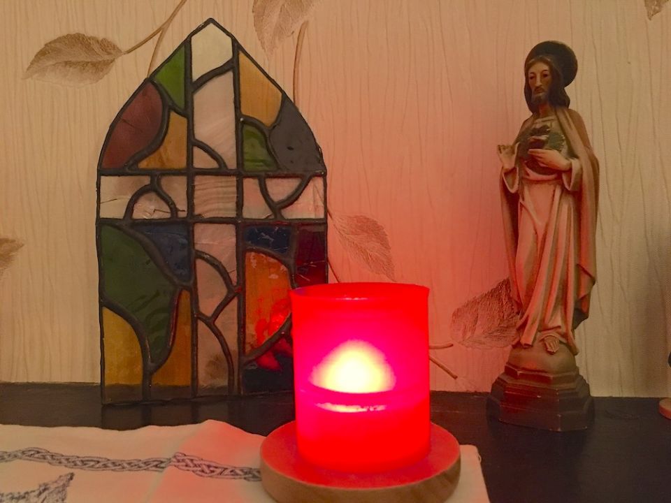 Candle and statue of Jesus on a table (Kathryn Press) Candle and statue of Jesus on a table (Kathryn Press)