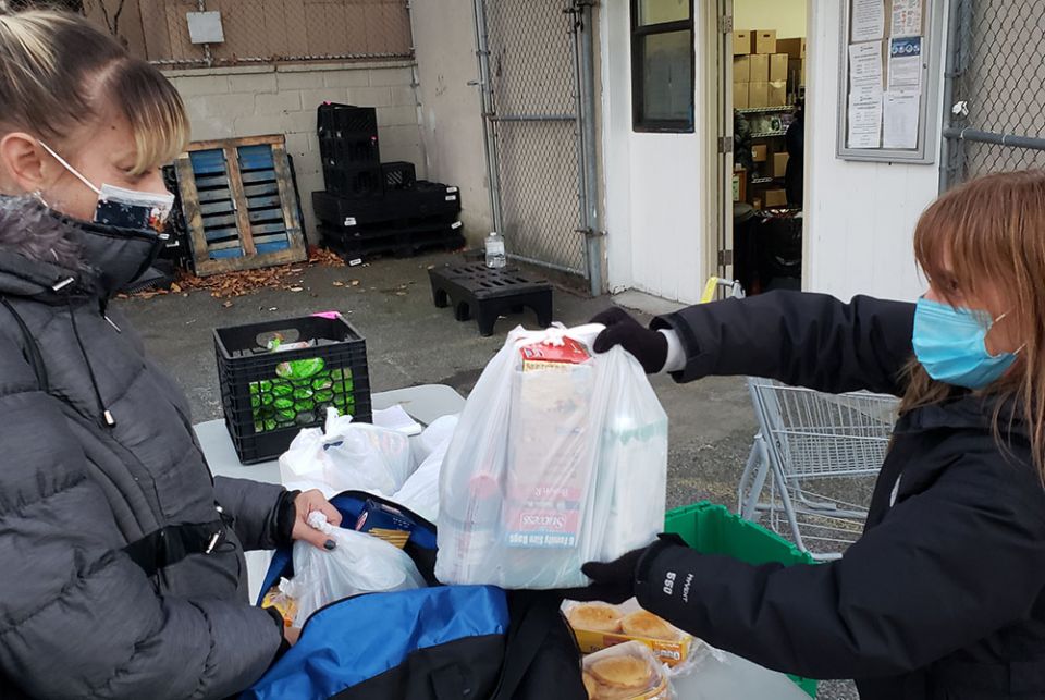Hour Children food pantry participant and Queens resident Jackie Terrasi, left, receives a food package from pantry coordinator Kellie Phelan. The pantry, based in New York City, is an initiative of Hour Children, a ministry headed by St. Joseph Sr. Tesa Hour Children food pantry participant and Queens resident Jackie Terrasi, left, receives a food package from pantry coordinator Kellie Phelan. The pantry, based in New York City, is an initiative of Hour Children, a ministry headed by St. Joseph Sr. Tesa
