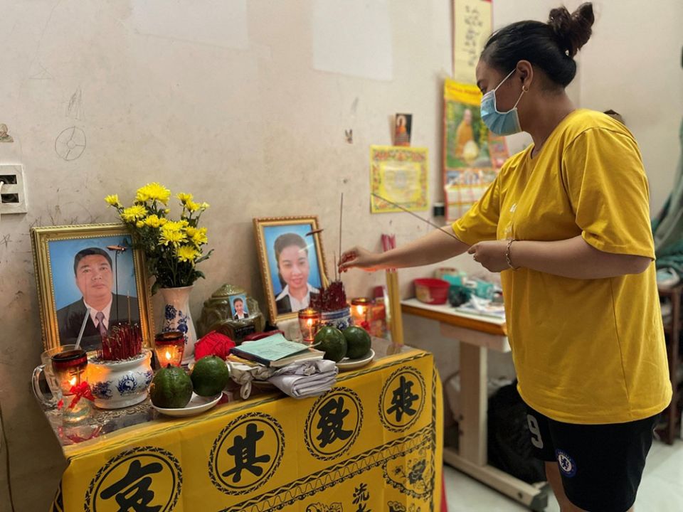 A 16-year-old girl in Ho Chi Minh City, Vietnam, prays for her parents lost in the COVID-19 pandemic this year. (Nguyen)