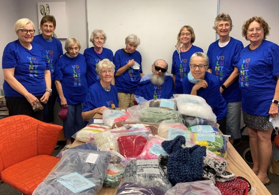 Some of the knitters in the Prayer Shawl Ministry of St. Giles Parish in Oak Park, Illinois, pose for a photo wearing T-shirts sent to them by a yarn donor. (Courtesy of Susan Paweski)