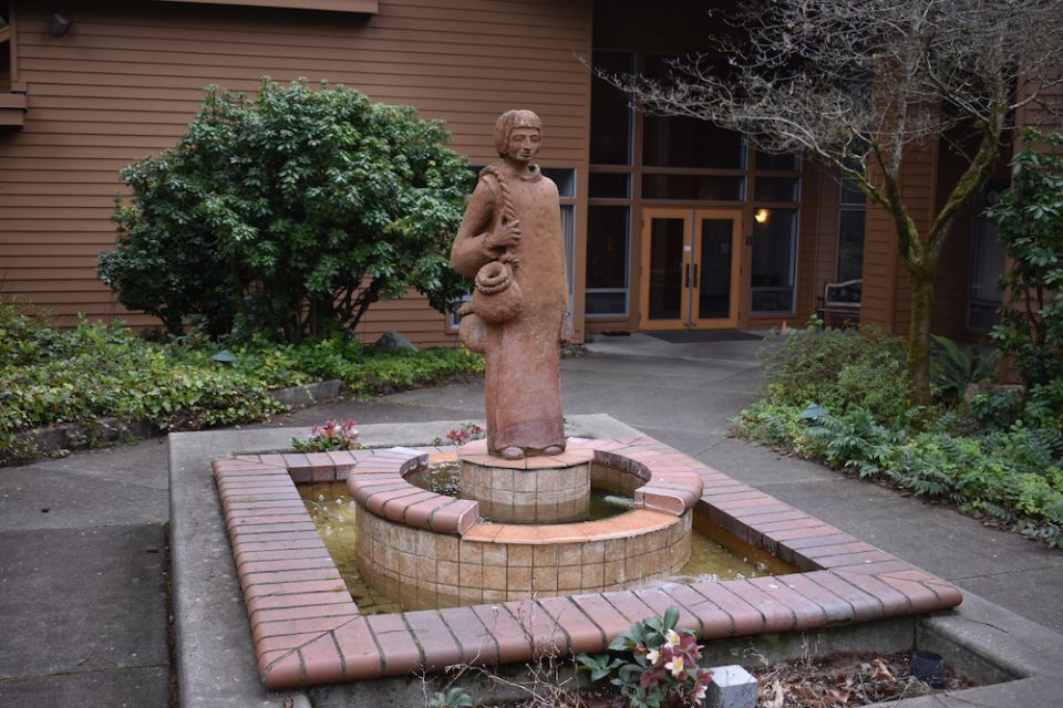 A statue of St. Placid stands outside the entrance of St. Placid Priory, Lacey, Washington, where women are accepted as claustral oblates, living inside the monastery with the sisters. (Julie A. Ferraro)