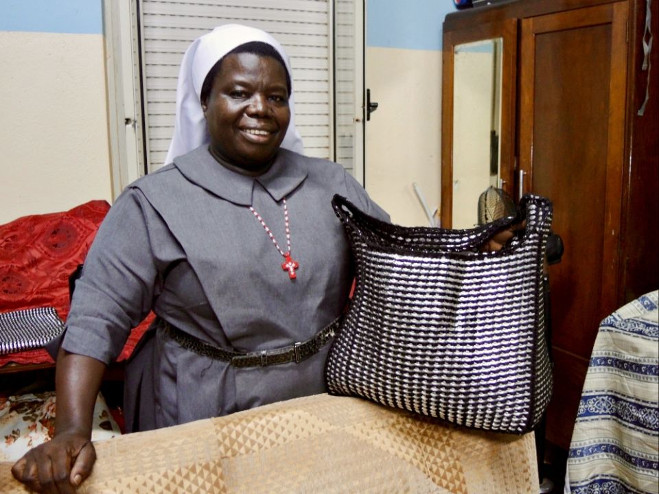 Sr. Rosemary Nyirumbe displays one of the "pop-top bags" made by students and graduates of St. Monica's Vocational School for Girls in Gulu, Uganda, in September 2017. (GSR photo/Melanie Lidman)