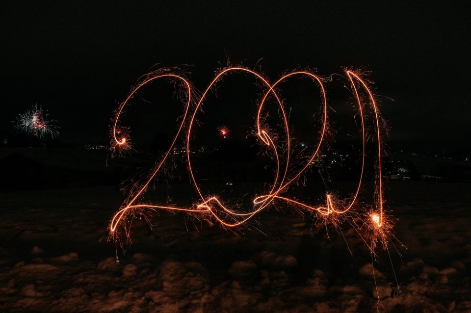 A sparkler spells out 2021 in the dark.