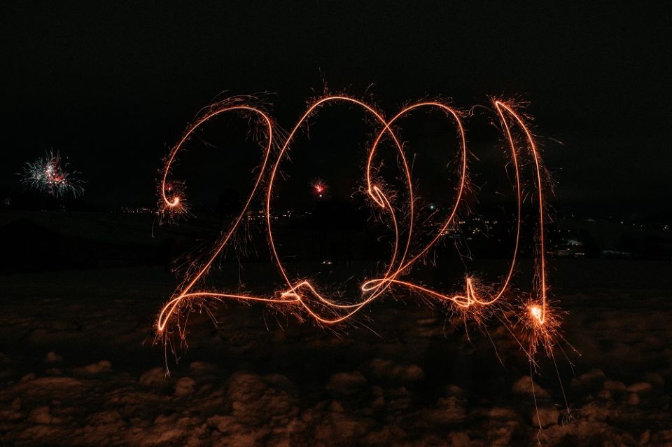 (Photo by Theodor Eilertsen Photography on Unsplash) A sparkler spells out 2021 in the dark.