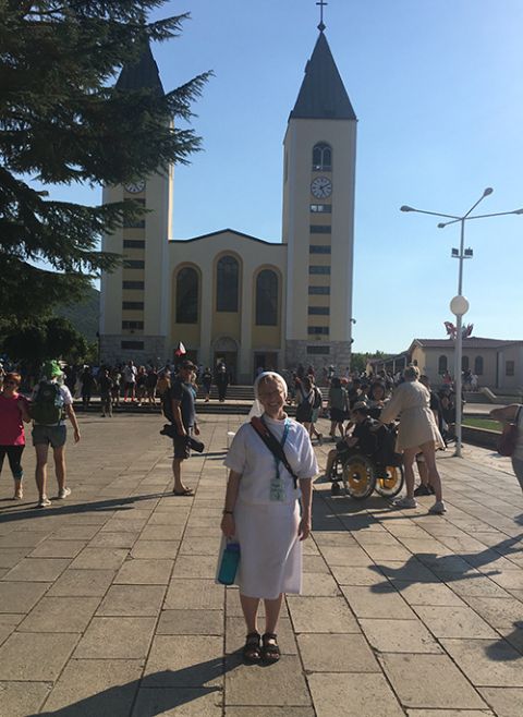 Sr. Kathryn Press stands outside St. James Church, the parish church for the village of Medjugorje, Bosnia-Herzegovina, in an August photo. (Courtesy of Kathryn Press)