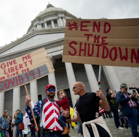 People in Olympia, Washington, protest the state's extended stay-at-home order April 19. (CNS / Reuters / Lindsey Wasson)