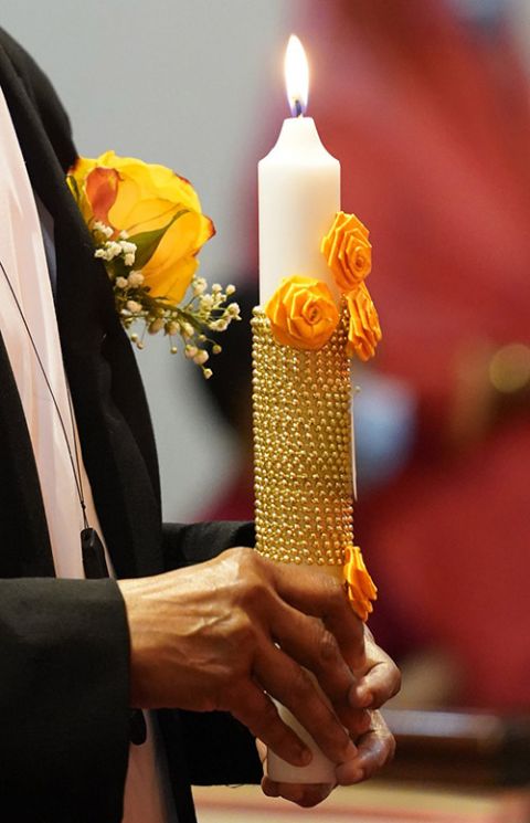A Sister of the Imitation of Christ holds a candle during a liturgy in New York state in May, when she marked her golden jubilee as a religious. (CNS/Gregory A. Shemitz)