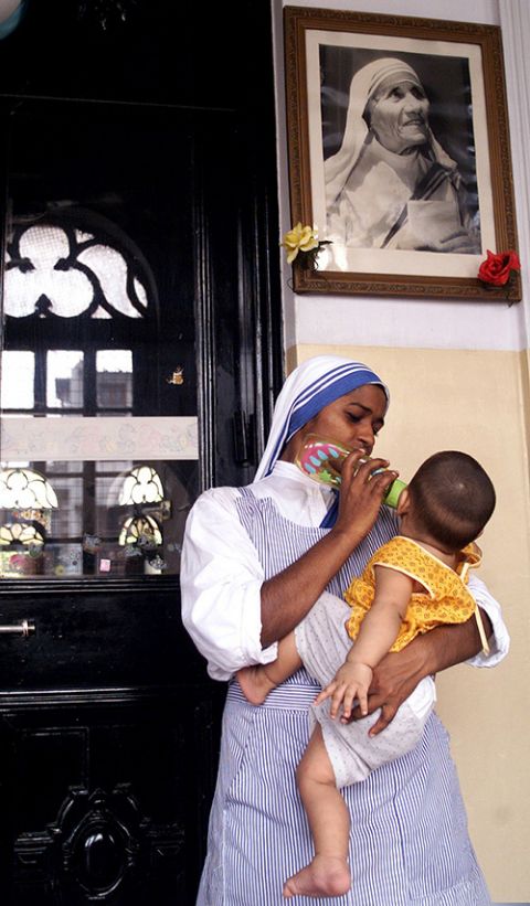 A member of the Missionaries of Charity is pictured in a file photo feeding a child at an orphanage in Kolkata, India. (CNS/Reuters)