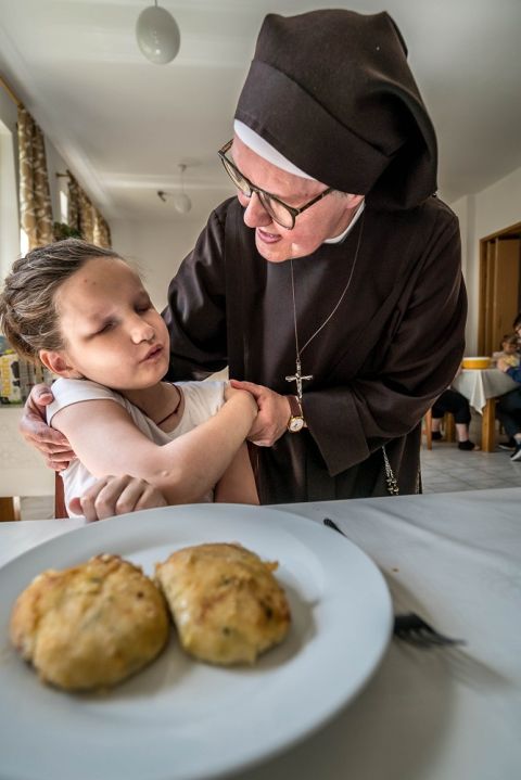 Sister Fabiana of the Franciscan Sisters Servants of the Cross hugs 10-year-old Katia, a blind refugee from Kyiv, Ukraine, on May 20. (CNS/Lisa Johnston)