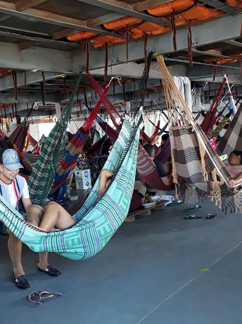 Passengers use hammocks to sleep on the dayslong trip along the Solimões River between Manaus and Tonantins in June 2020. (Courtesy of Sr. Alessandra dos Santos Santana)