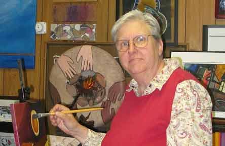 Dominican Sr. Barbara Schwarz poses while working on a painting focused on migration. (Courtesy of Barbara Schwarz)
