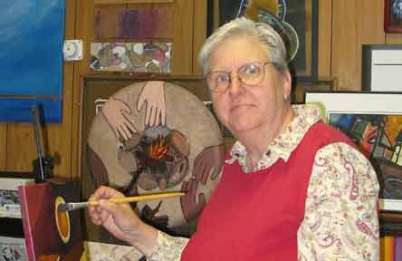 Dominican Sr. Barbara Schwarz poses while working on a painting focused on migration. (Courtesy of Barbara Schwarz) Dominican Sr. Barbara Schwarz poses while working on a painting focused on migration. (Courtesy of Barbara Schwarz)