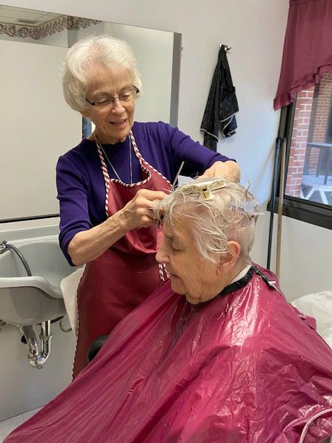 Sr. Micaela Randolph of the Benedictine Sisters of Mount St. Scholastica cuts Sr. Jeanne d'Arc Kernion's hair. (Courtesy of the Benedictine Sisters of Mount St. Scholastica)