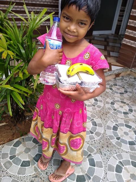 A child holds food and water given by the Daughters of St. Anne. Sisters and novices from several Daughters of St. Anne provinces have been preparing and distributing lunch packets at St. Anne's Hospital & Research Centre in Raja Ulhatu, Jharkhand, India.