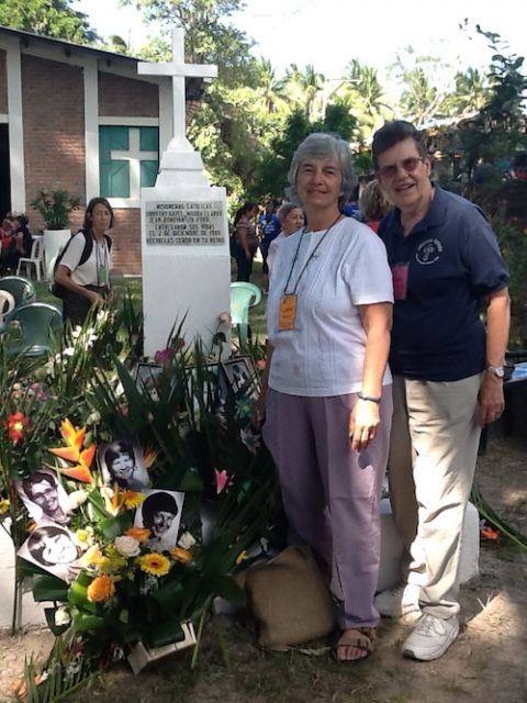 Ursuline Srs. Carol Reamers of Toledo, Ohio, and Janet M. Peterworth of Louisville, Kentucky, at the grave marker for the four murdered churchwomen in El Salvador in 2015 (Provided photo)