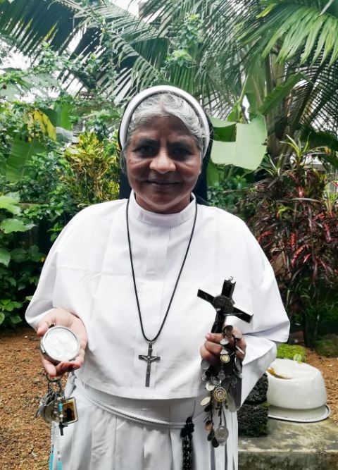 Franciscan Clarist Sr. Lissy Vadakkel, a key witness in the rape case against Bishop Franco Mulakkal, displays lockets of saints, a rosary, religious relics and a crucifix engraved with "Missionaries of Jesus," the congregation of the rape survivor. Franciscan Clarist Sr. Lissy Vadakkel, a key witness in the rape case against Bishop Franco Mulakkal, displays lockets of saints, a rosary, religious relics and a crucifix engraved with "Missionaries of Jesus," the congregation of the rape survivor.