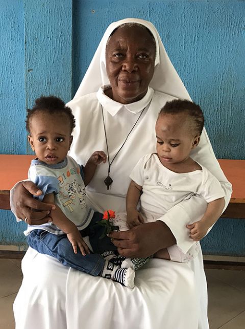 Sr. Matilda Inyang with two children at the Mother Charles Walker Children Home on May 7 at the Handmaids of the Holy Child Jesus convent in Uyo, Nigeria. Many of the children at the home had family who believed they were witches. (Valentine Iwenwanne)