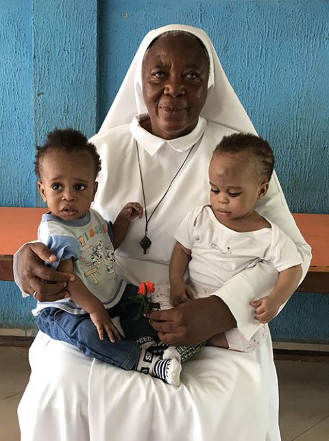 Matilda Inyang Sr. Matilda Inyang with two children at the Mother Charles Walker Children Home on May 7 at the Handmaids of the Holy Child Jesus convent in Uyo, Nigeria. Many of the children at the home had family who believed they were witches. (Valentine Iwenwanne)
