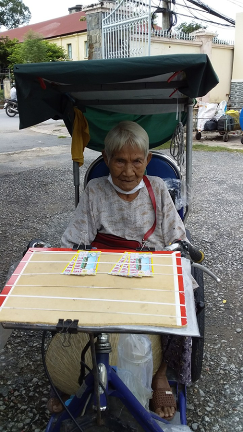 A 75-year-old woman sells lottery tickets to feed herself and her son, who is disabled. (Mary Nguyen Thi Phuong Lan)