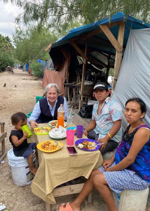 Sr. Norma Pimentel, second from left, says she is always deliberate about visiting the families and sharing a meal on her trips to the migrant camp in Matamoros, Mexico, in the pandemic. The Missionary of Jesus said she never just drops things off.