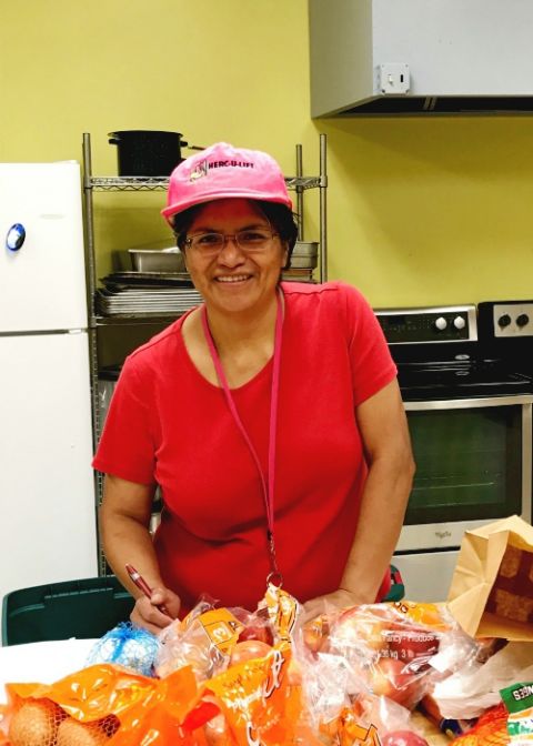 Dubuque Franciscan Sr. Reyna Helen Badillo sorts through food to be delivered in Mississippi. (Courtesy of Sr. Nancy Schreck) Dubuque Franciscan Sr. Reyna Helen Badillo sorts through food to be delivered in Mississippi. (Courtesy of Sr. Nancy Schreck)
