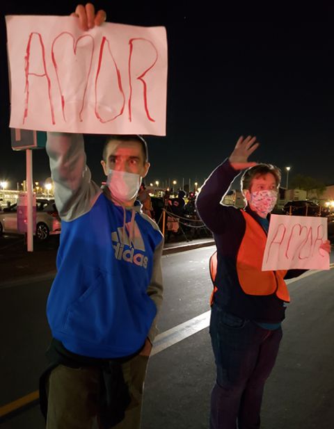 Sean Farry, left, and Mercy Sr. Mary Kay Dobrovolny, both members of Casa de Misericordia, welcome a group of unaccompanied minors arriving at the San Diego Convention Center on March 20. (Courtesy of the Sisters of Mercy of the Americas)