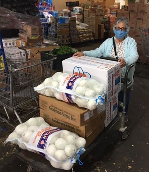 Benedictine Sr. Ursula Herrera buys food to distribute in Piedras Negras, Mexico. She makes regular food and supply runs to a home for special-needs adults and an orphanage on the Mexico side of the U.S.-Mexico border. (Courtesy of John Bivens)