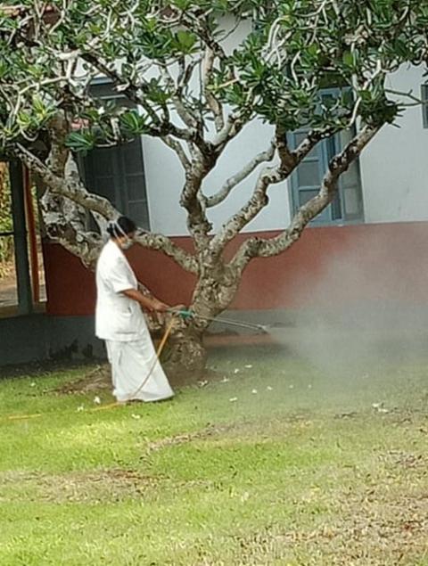 Medical Mission Sr. Annie Vettukattil, nursing superintendent, sanitizes the surroundings of Immaculate Heart of Mary Hospital in Kerala, India, in the absence of ground maintenance staff. (Courtesy of Mini Amalolbhavam) Medical Mission Sr. Annie Vettukattil, nursing superintendent, sanitizes the surroundings of Immaculate Heart of Mary Hospital in Kerala, India, in the absence of ground maintenance staff. (Courtesy of Mini Amalolbhavam)