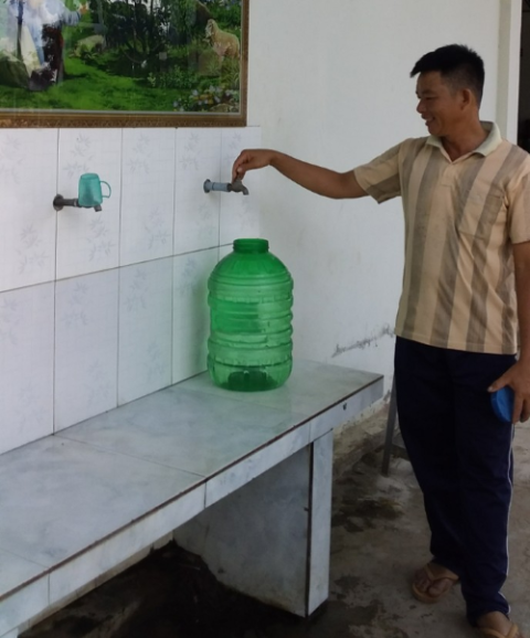 A Catholic man collects purified water, which is safer than the polluted water from the Mekong River. (Mary Nguyen Thi Phuong Lan)