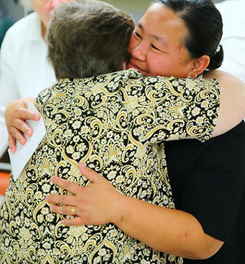 Sister Cristina giving someone a hug (before the COVID-19 pandemic); she is known for giving wonderful hugs. (Courtesy of Franciscan Sisters of the Sacred Heart)