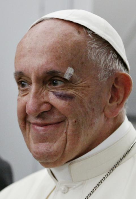 Pope Francis smiles aboard his flight from Cartagena, Colombia, to Rome Sept. 10, 2017. Earlier, the pope cut and bruised his face on the popemobile window when he was greeting people. (CNS/Paul Haring)