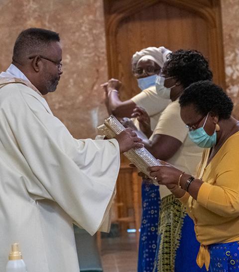 Deacon Rick Fortune receives the Book of the Gospels at the Cathedral of St. Francis of Assisi in Metuchen, New Jersey, June 19, 2020, during a prayer service for racial harmony. (CNS/Courtesy of Metuchen Diocese/Gerald Wutkowski Jr.)