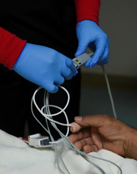 A health care worker adjusts a monitor on a patient's hand at United Memorial Medical Center in Houston Sept. 30. Texas ranks 50th in the United States for access to affordable health care. (CNS/Reuters/Callaghan O'Hare)