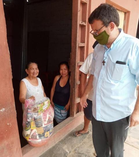 Fr. Raymond Portelli, who has worked in the Peruvian Amazon for nearly three decades, distributes food baskets in Iquitos on Christmas 2020. (CNS/courtesy Fr. Raymond Portelli)