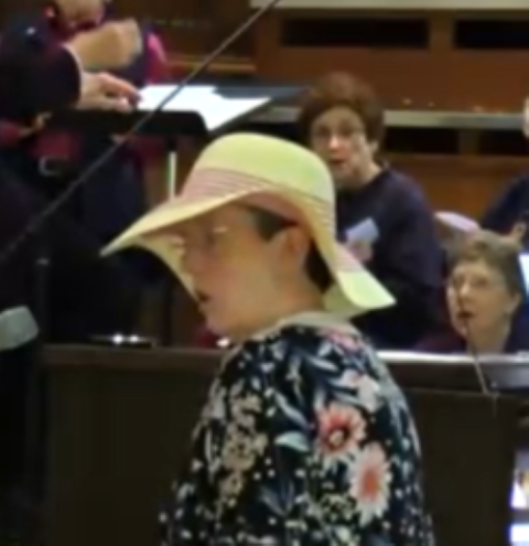 2.	Sr. Jane Marie Bradish sang Greg Norbet's hymn "All I Ask of You" at Sister Thoma's funeral. Bradish  wore a wide-brimmed hat in honor of her friend. (Courtesy of Jane Marie Bradish)