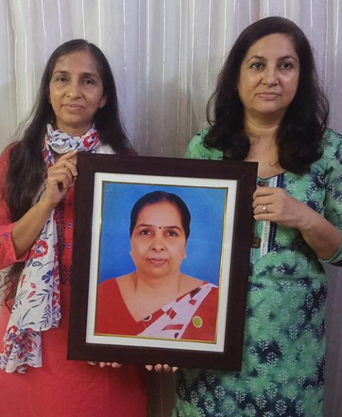 Jaishree Sabharwal, right, and her sister, Poonam Sethi, hold a photo of their mother at their home in New Delhi. Their mother died Sept. 13 under the care of Sisters of the Holy Cross in Menzingen at Shanti Avedna Sadan in New Delhi. (Courtesy of Jaishree Sabharwal)