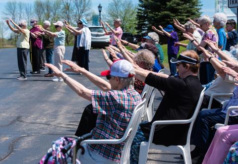 Members of the Sisters of St. Francis of the Holy Cross in Green Bay, Wisconsin, raise their arms May 14 during the blessing of a monument with a plaque that acknowledges "the First Nations people who are the original inhabitants of this region." (CNS/The
