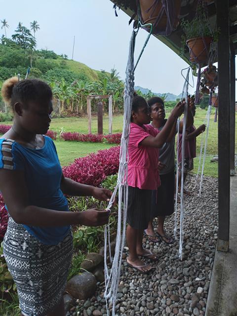 Students learn to weave macrame in Sr. Sonia Tulili's life skills class in September 2021 at San Isidore Care Centre. Tulili learned macrame from the fashion association in Honiara, the capital city of Solomon Islands. (Courtesy of Maria Fe Rollo)