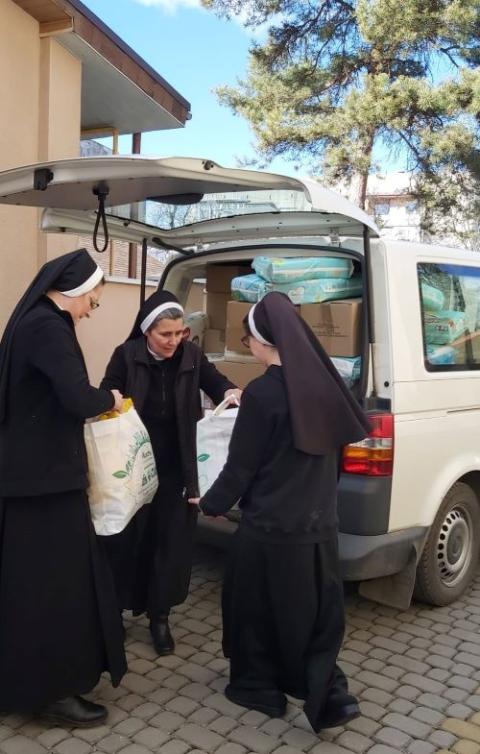 Mother Marcela Runcan, center, and sisters from Romania deliver humanitarian aid to Mukachevo, Ukraine, on March 8, 2022. 